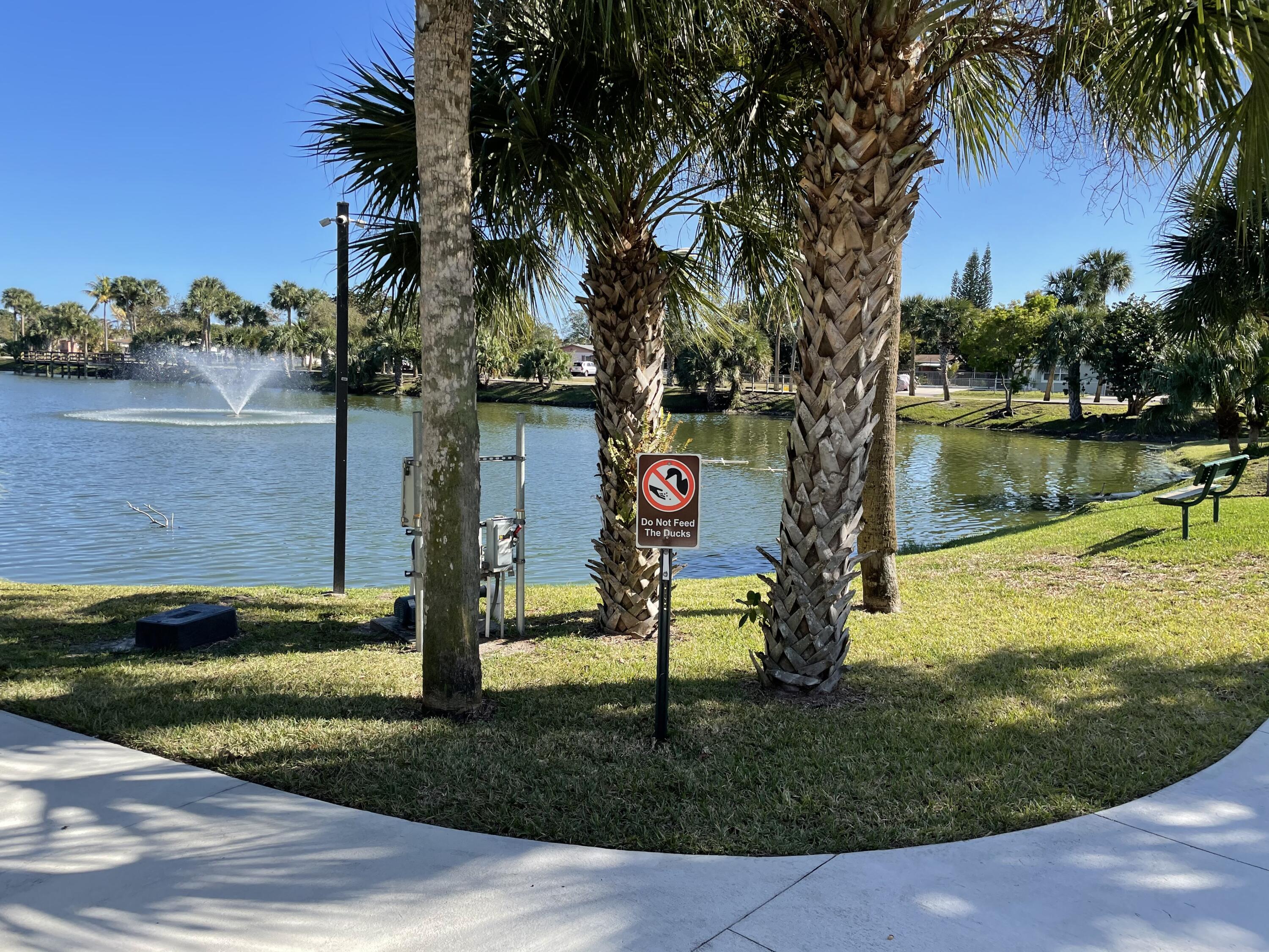 a front view of a house with a yard and lake view