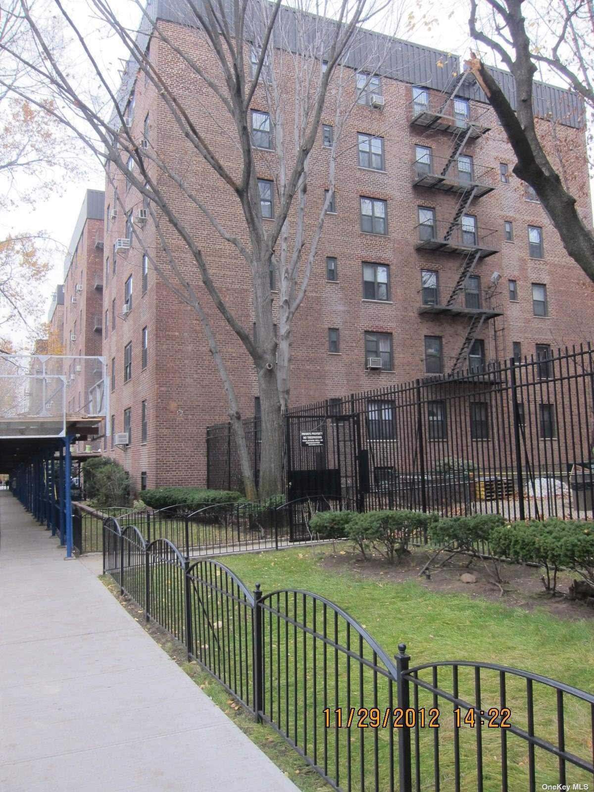 a view of a brick building next to a yard