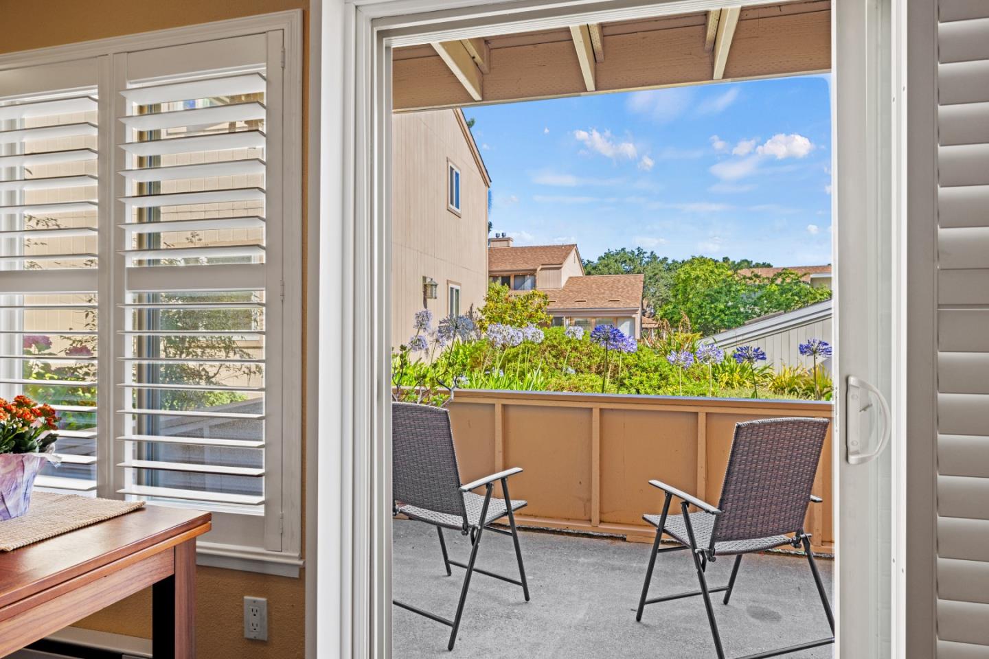 a view of a chairs and table in a balcony