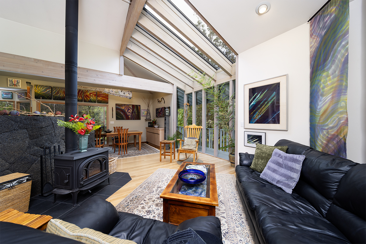 a living room with furniture fireplace and a large window