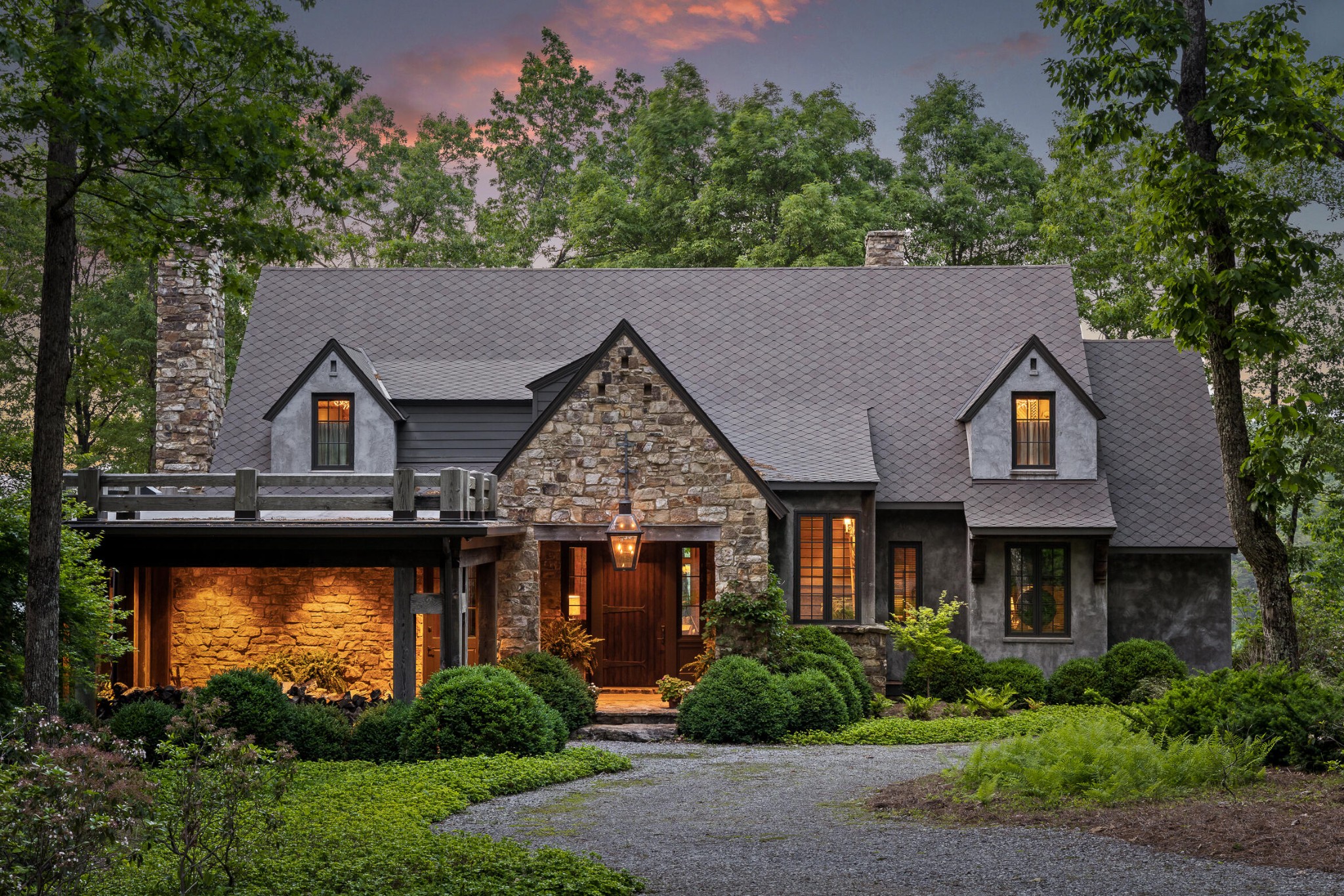 a front view of a house with a yard and lake view