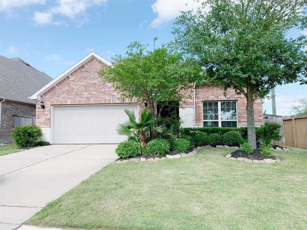 a front view of a house with a yard and a garage