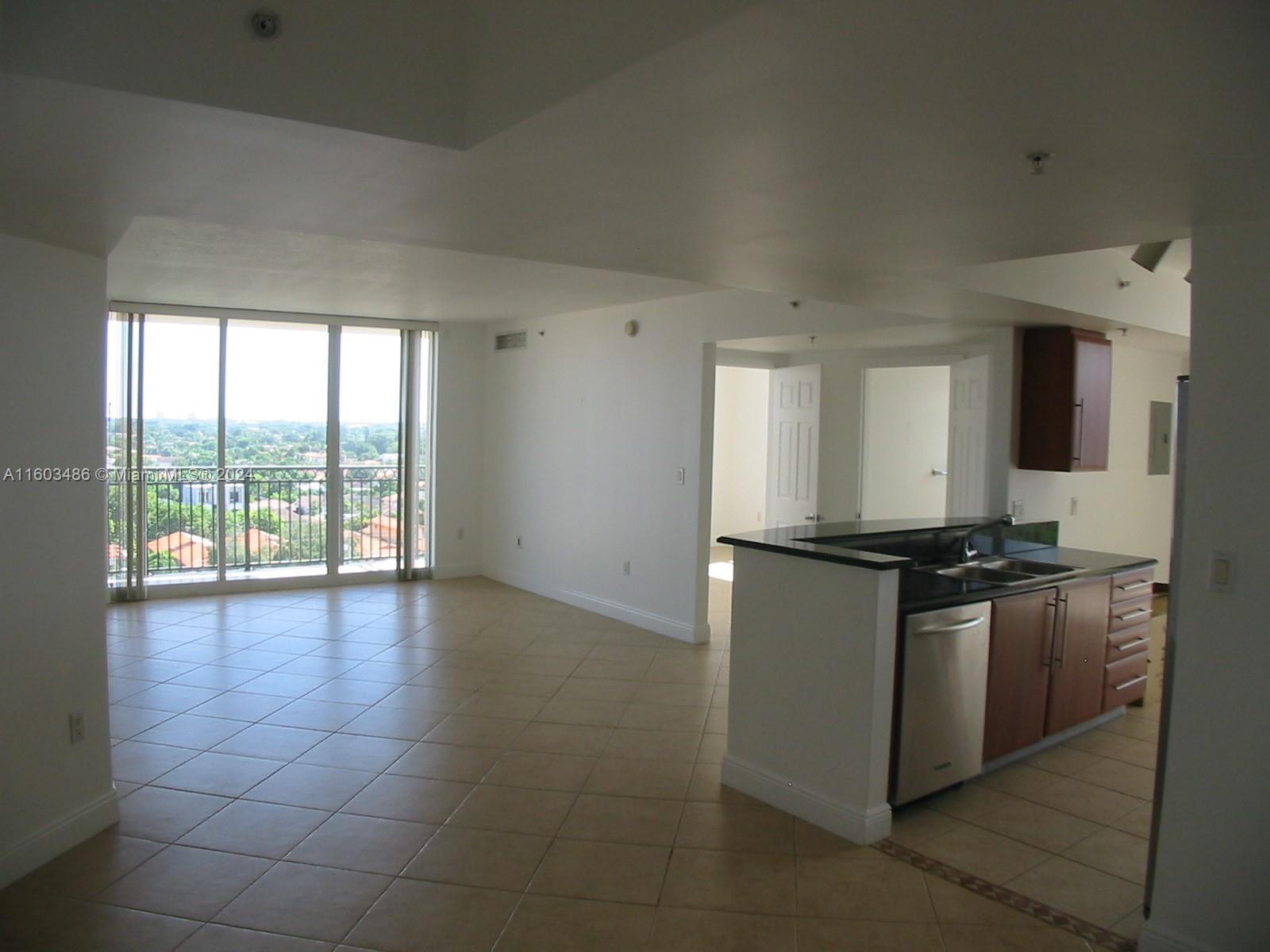 a kitchen with stainless steel appliances granite countertop a stove and a refrigerator