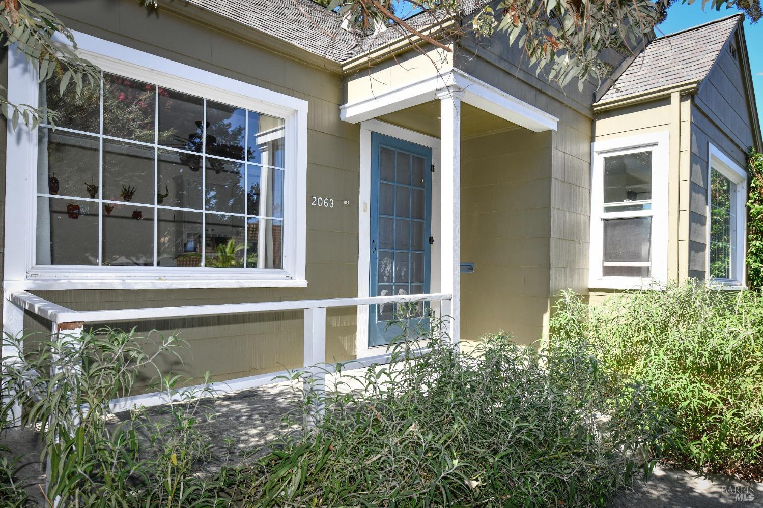 front view of a house with a large window