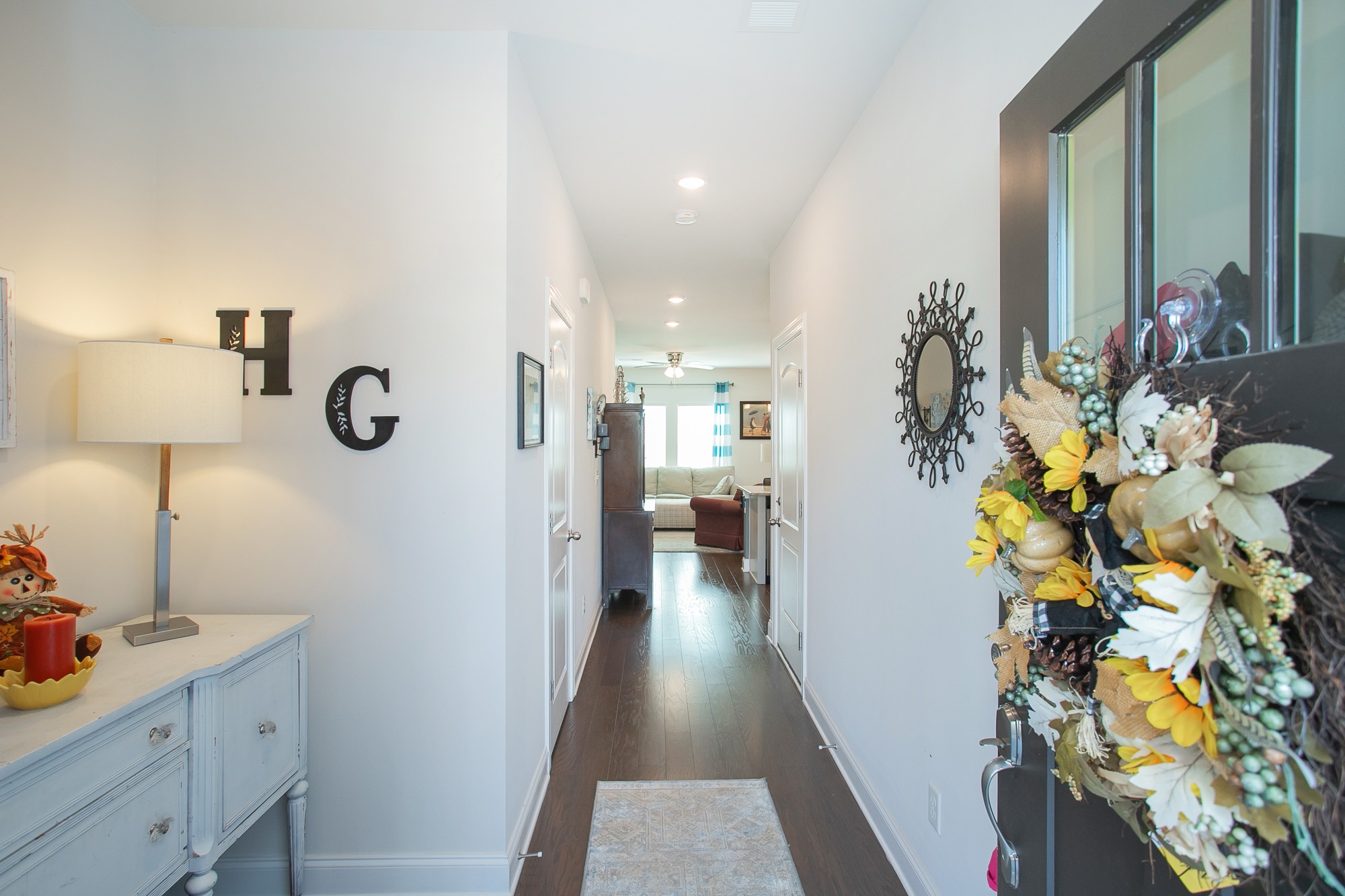 a view of a hallway and a livingroom with furniture