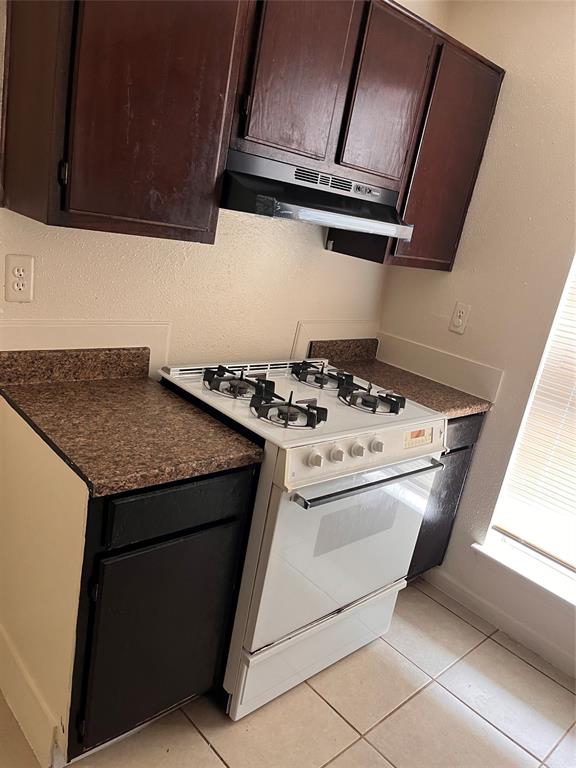 a stove top oven sitting inside of a kitchen