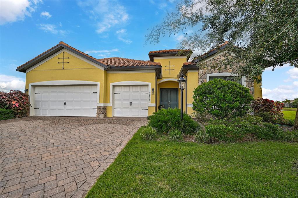 a front view of a house with a yard and garage