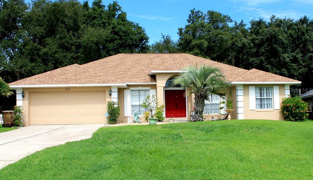 a front view of a house with a garden and yard