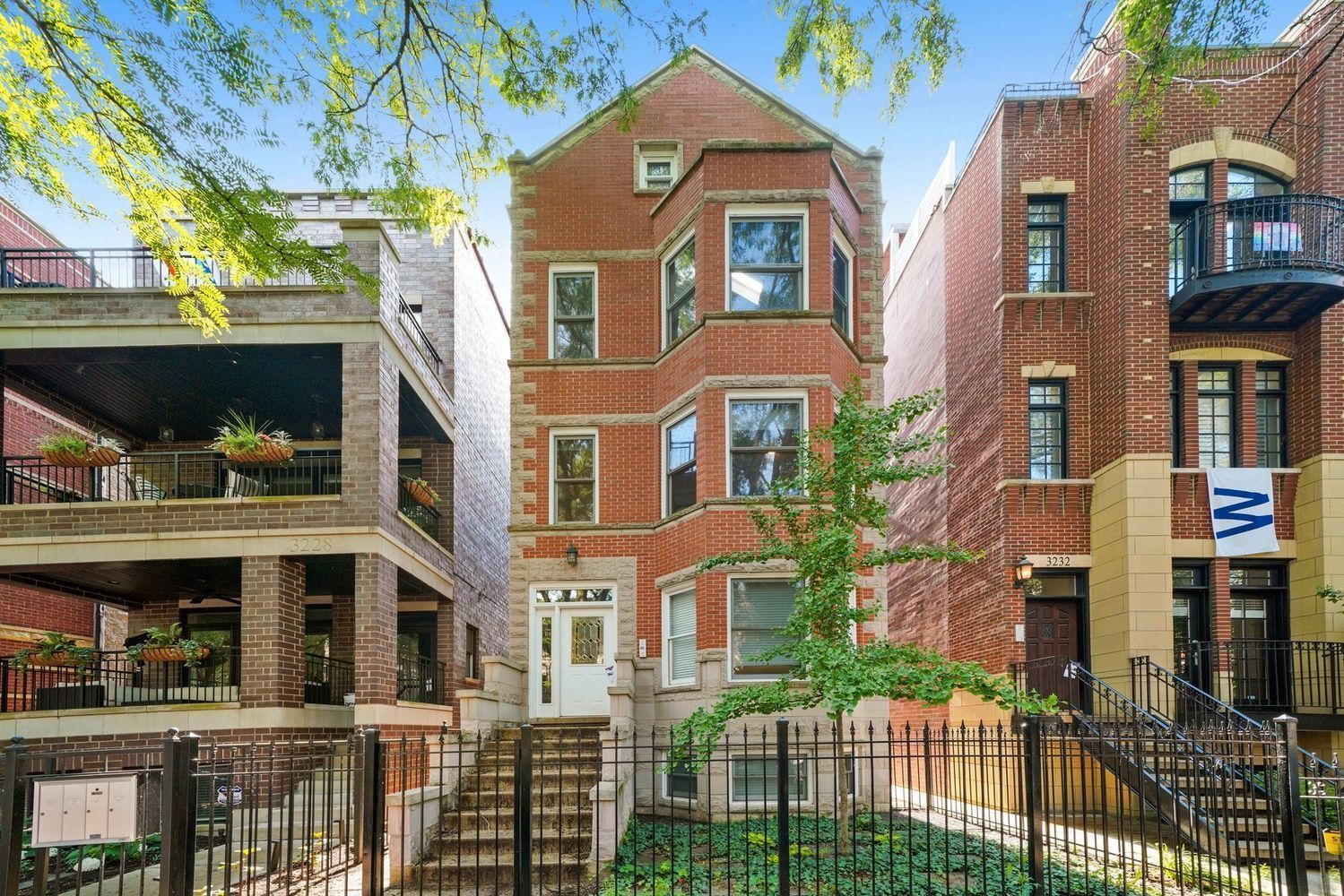 a front view of a residential apartment building with a yard