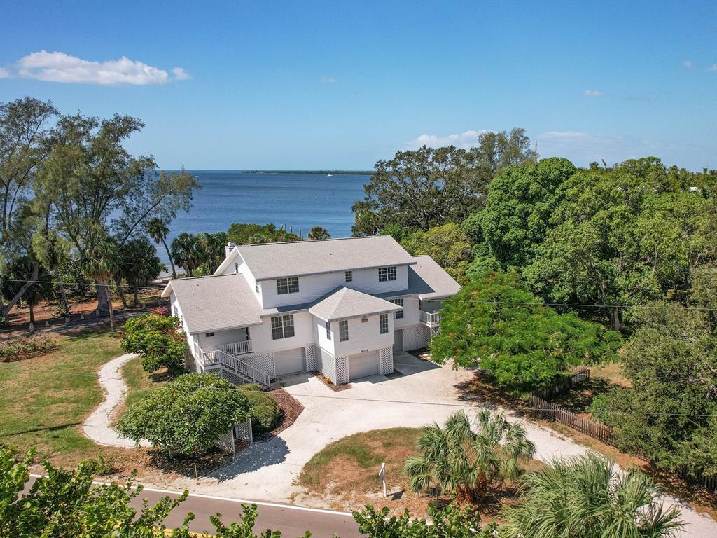 a aerial view of a house with a yard basket ball court and outdoor seating