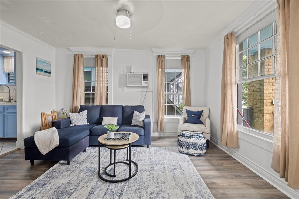 a living room with furniture a table and a large window