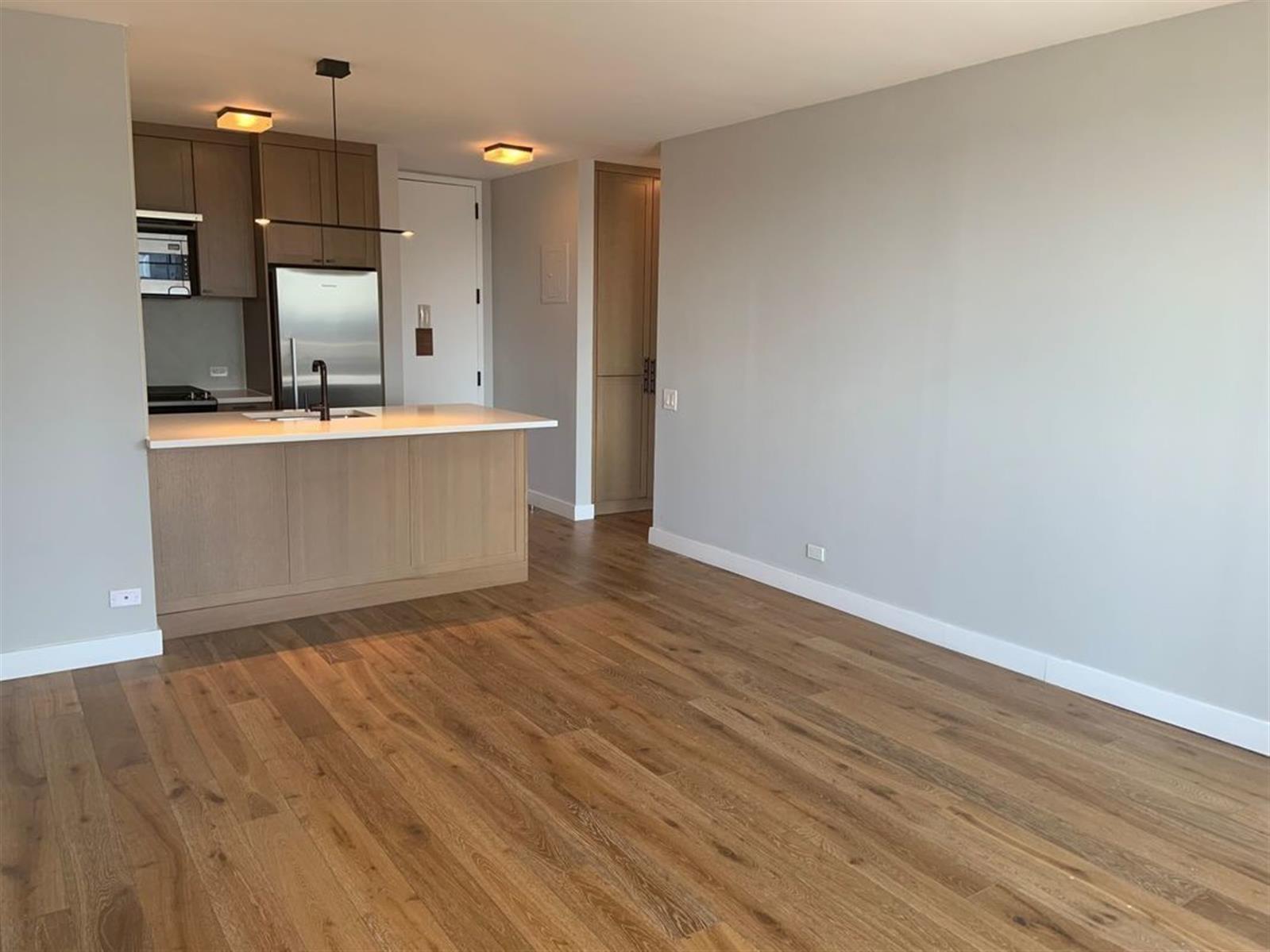 a view of kitchen and wooden floor