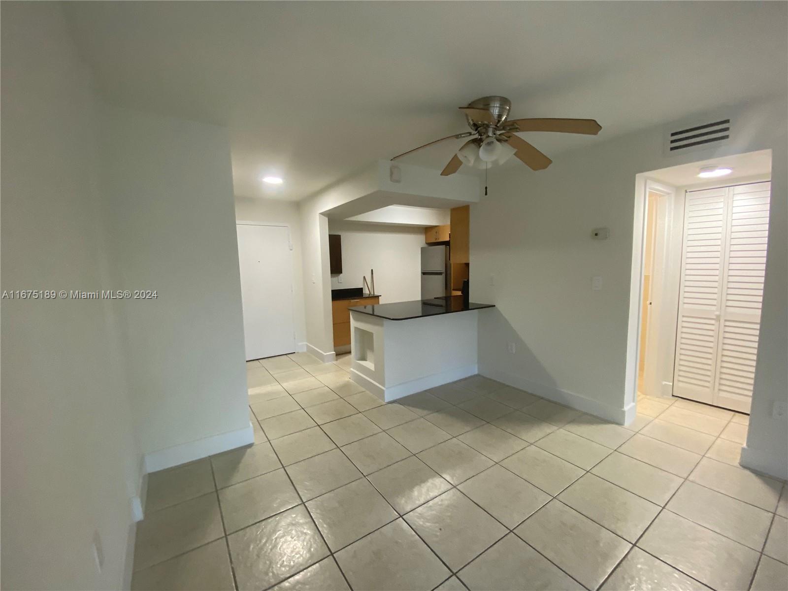 a view of a kitchen with a sink and cabinets