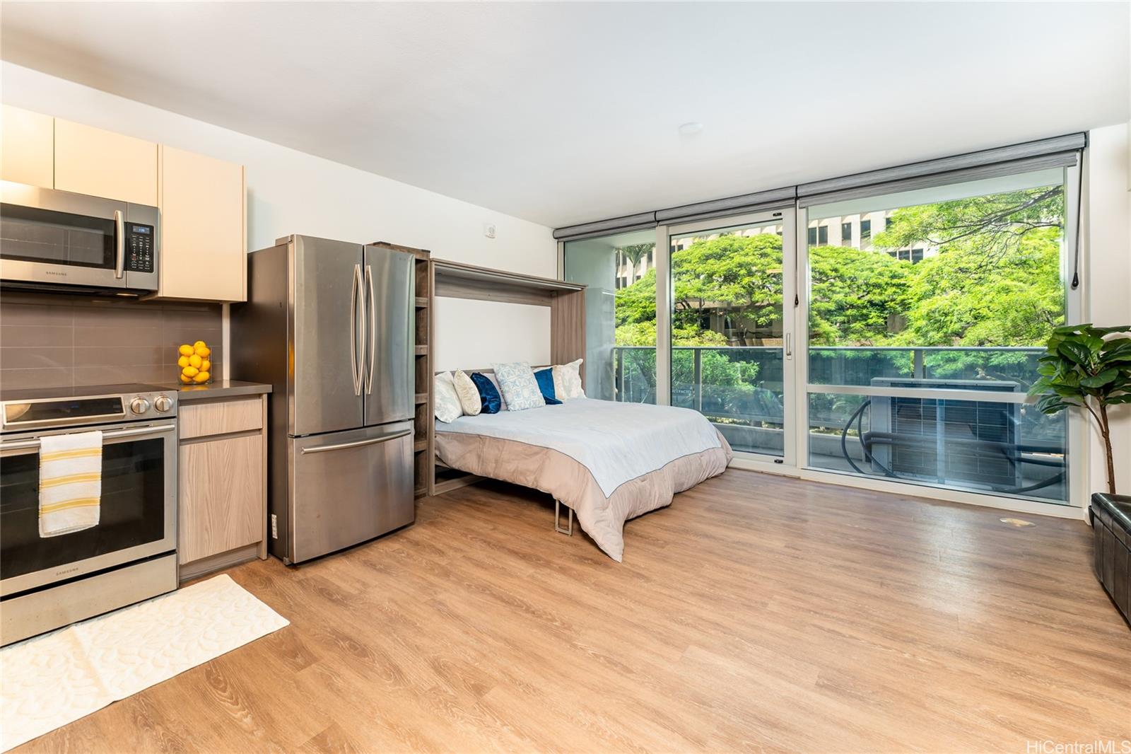 a bedroom with a bed flat screen tv and a large window