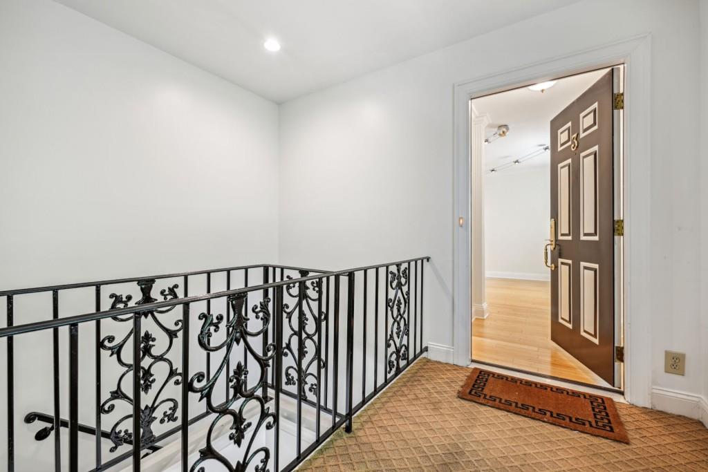 a view of a hallway with wooden floor