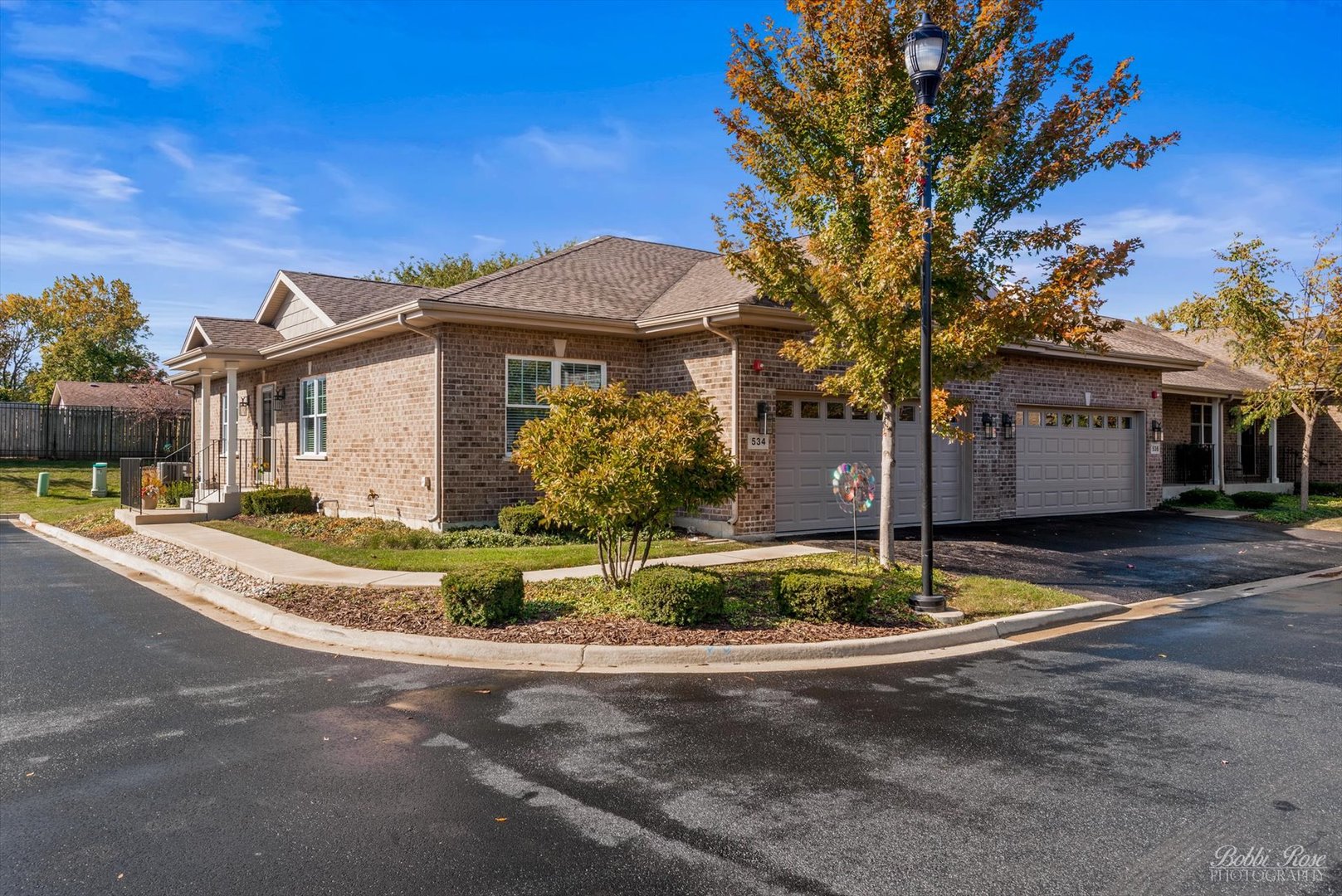 a front view of a house with a yard garage and outdoor seating