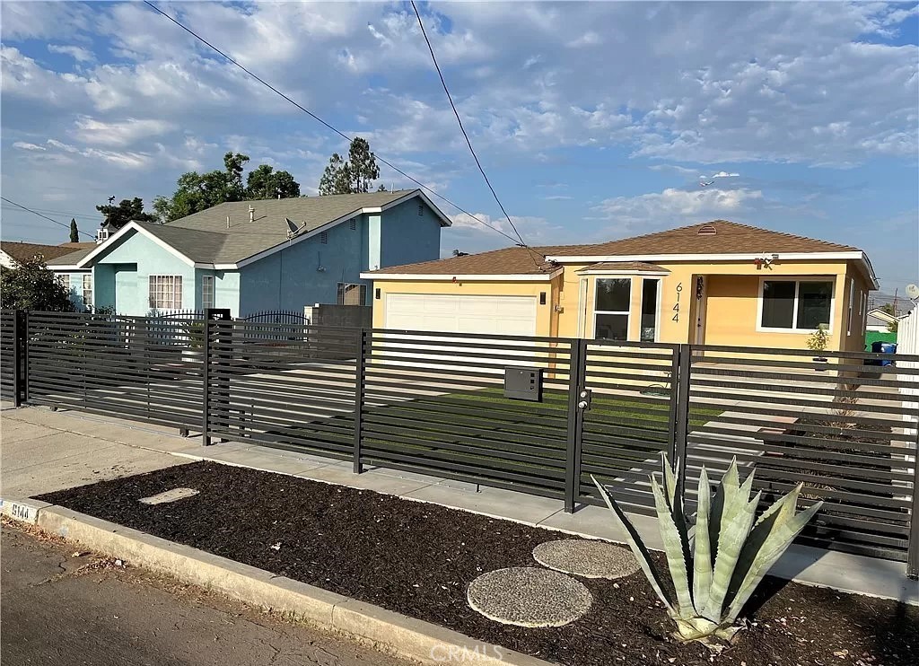 a front view of a house with garden