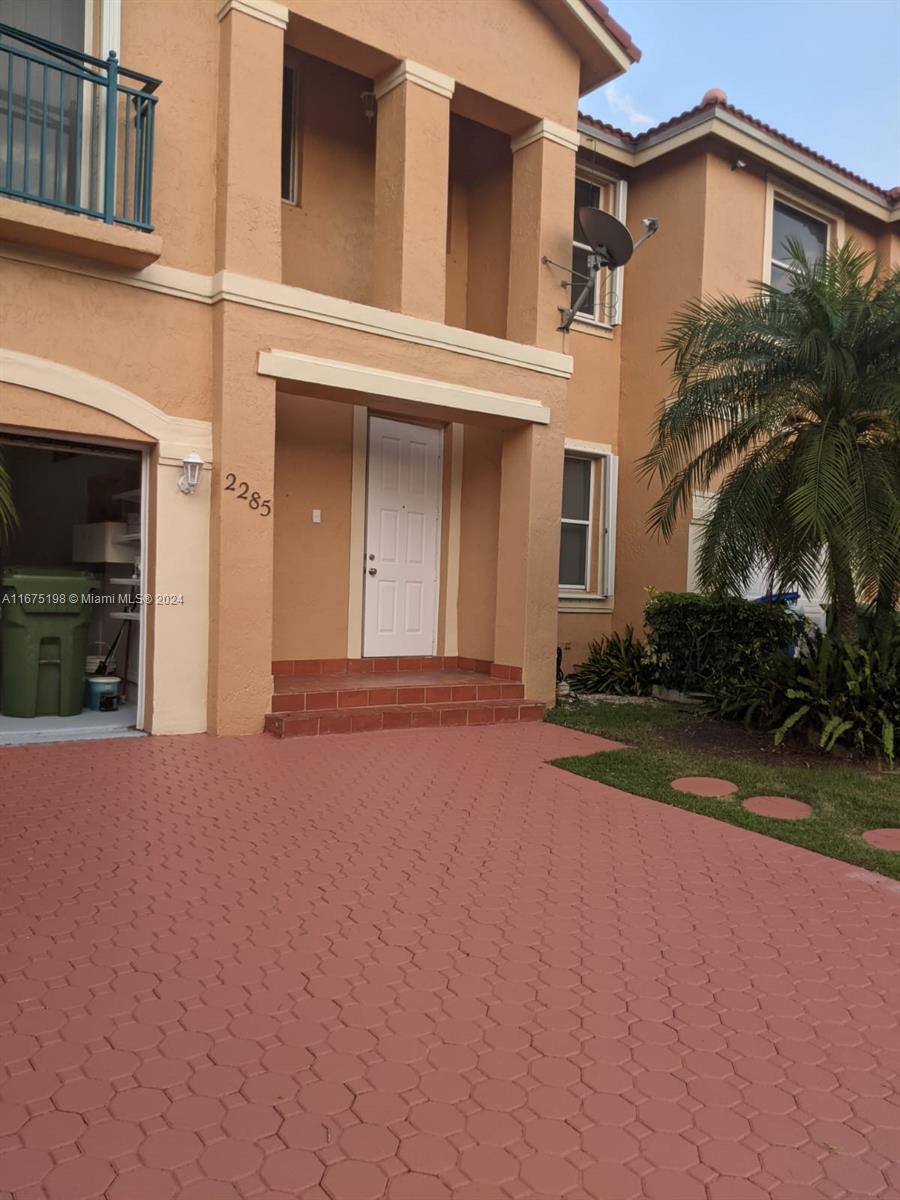 front view of a house with a yard and a garage