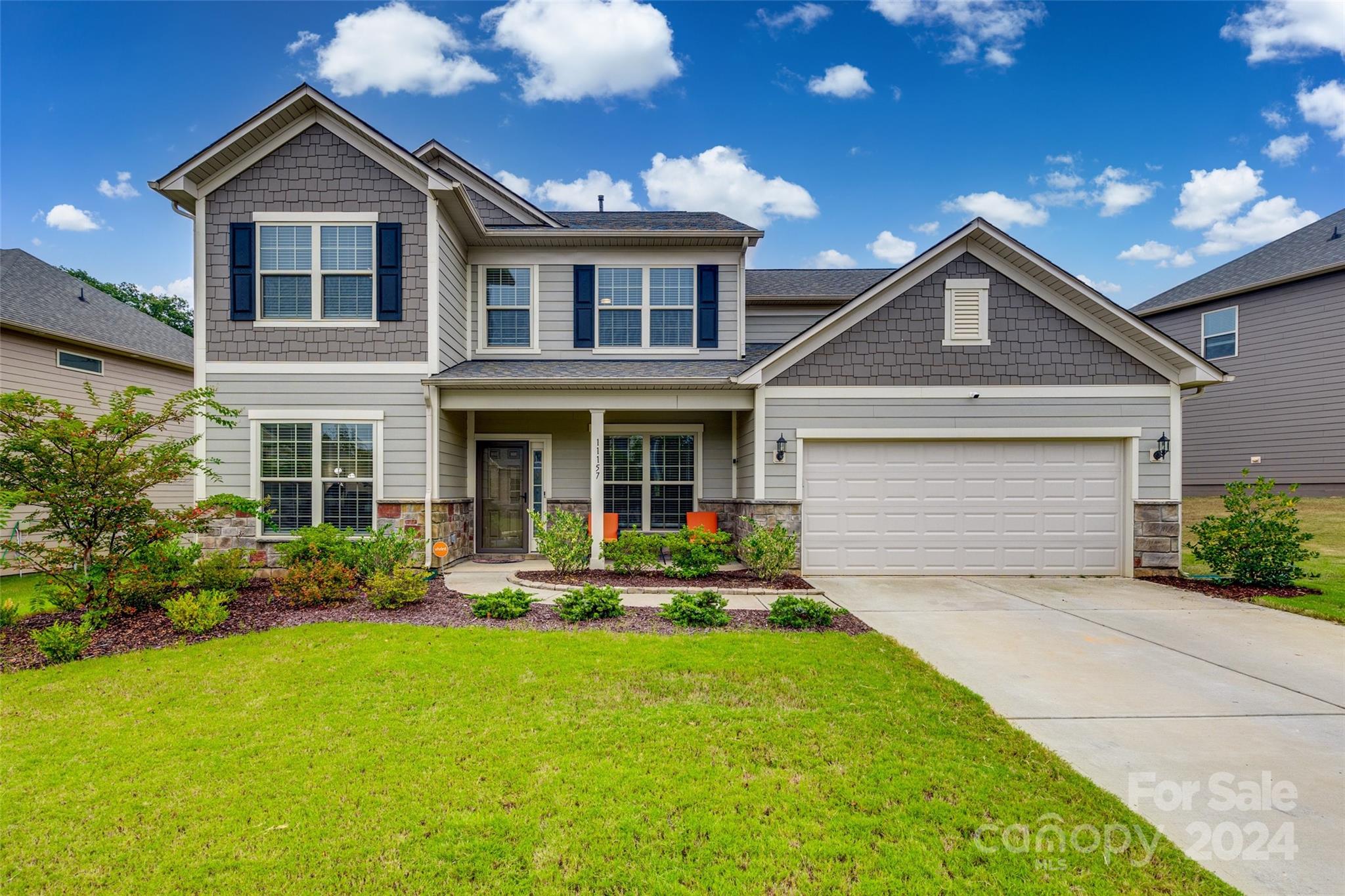 a front view of a house with a yard and garage