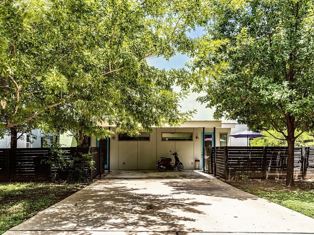 a view of a house with a tree beside it