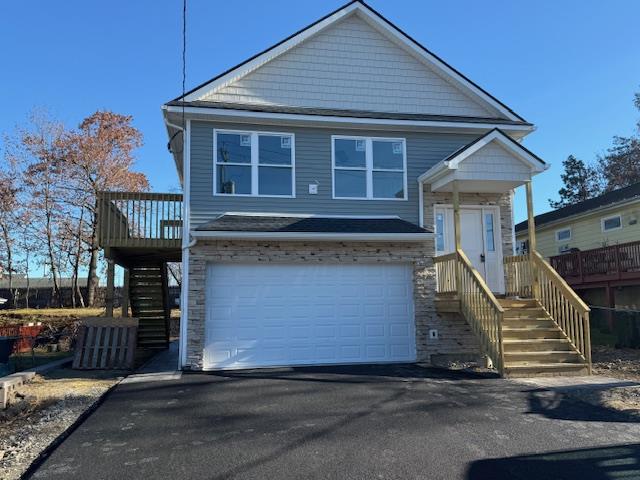 View of front of home featuring a 2 car garage with garage door opener