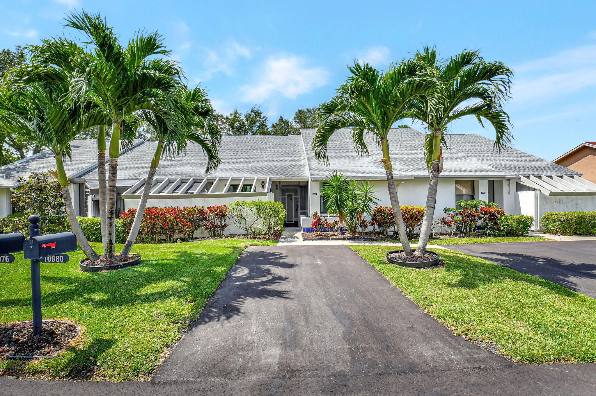 a view of a house with a yard and tree s