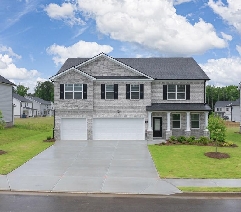 a front view of house with yard and green space