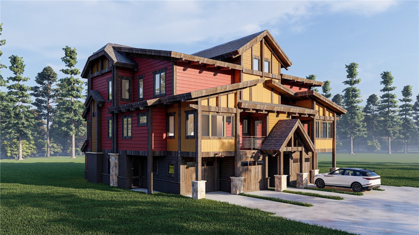 a front view of a house with a small yard and deck