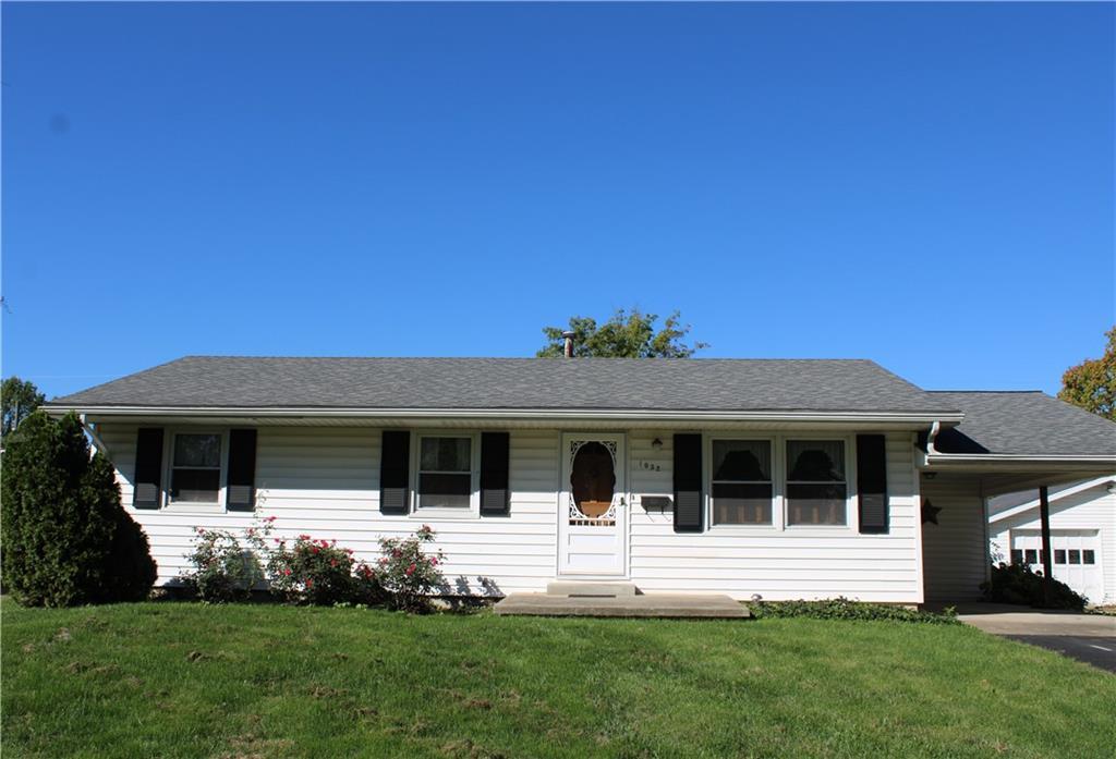 a front view of house with a garden