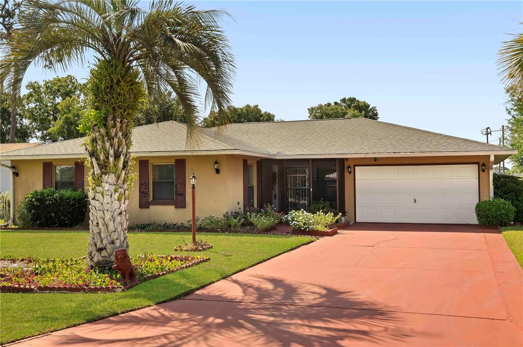 a front view of a house with a garden and yard