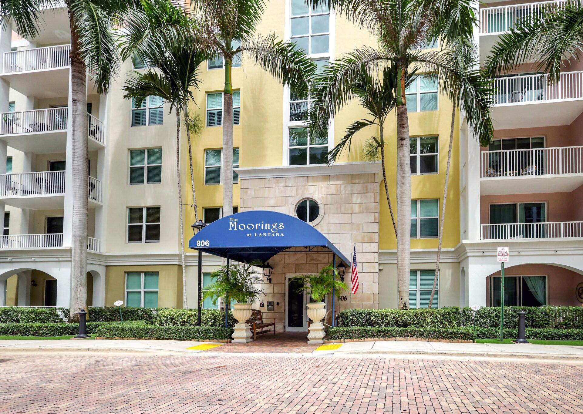 a front view of a building with a garden