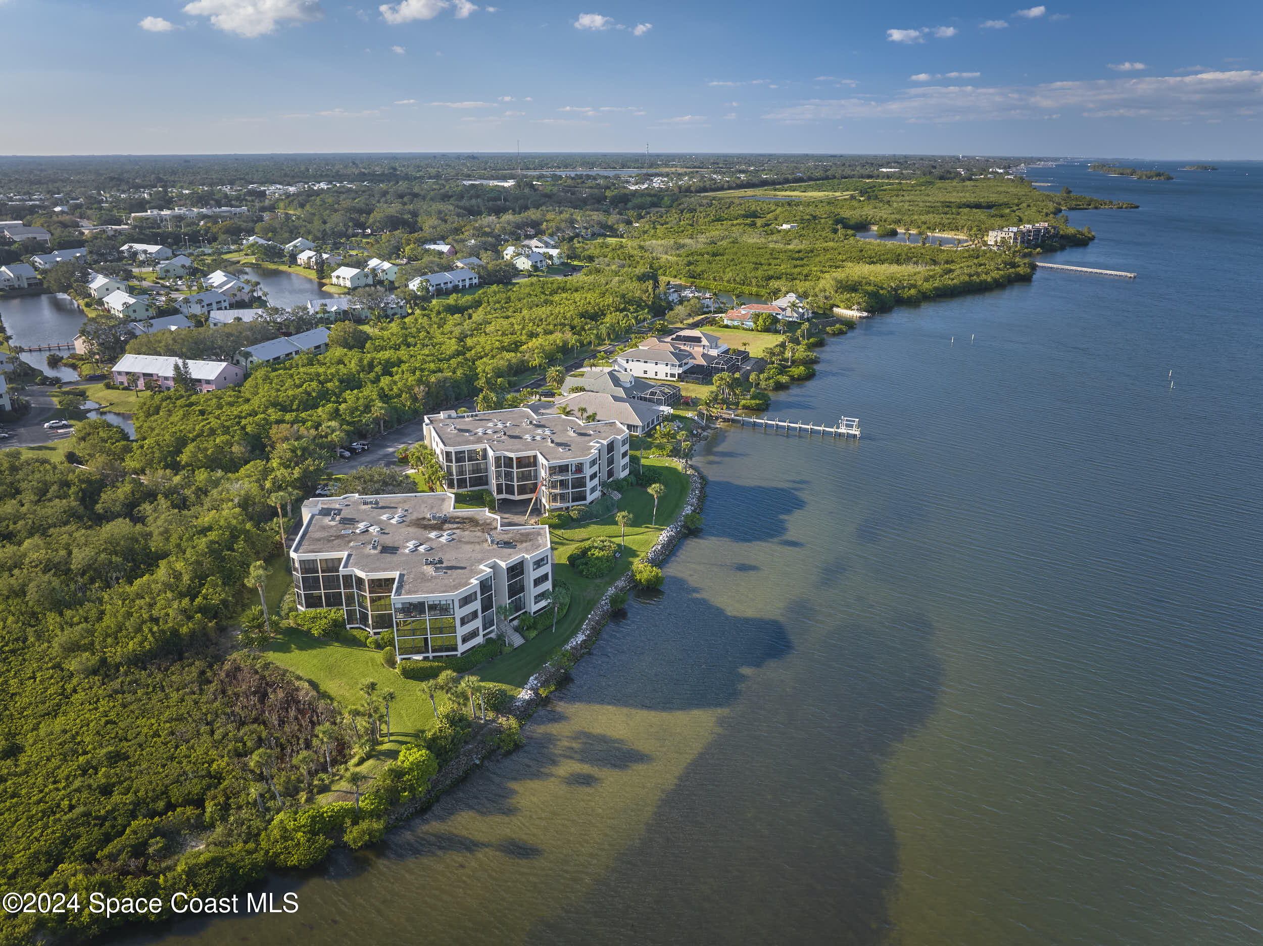 an aerial view of a houses with a lake view