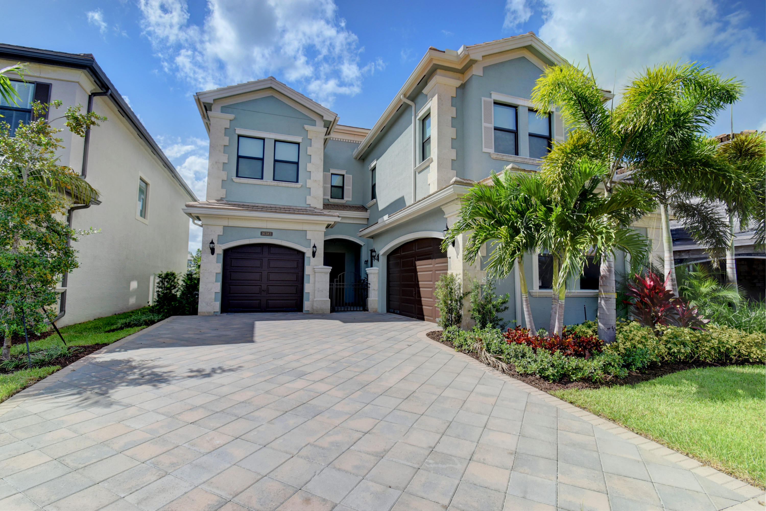 a front view of a house with yard and trees