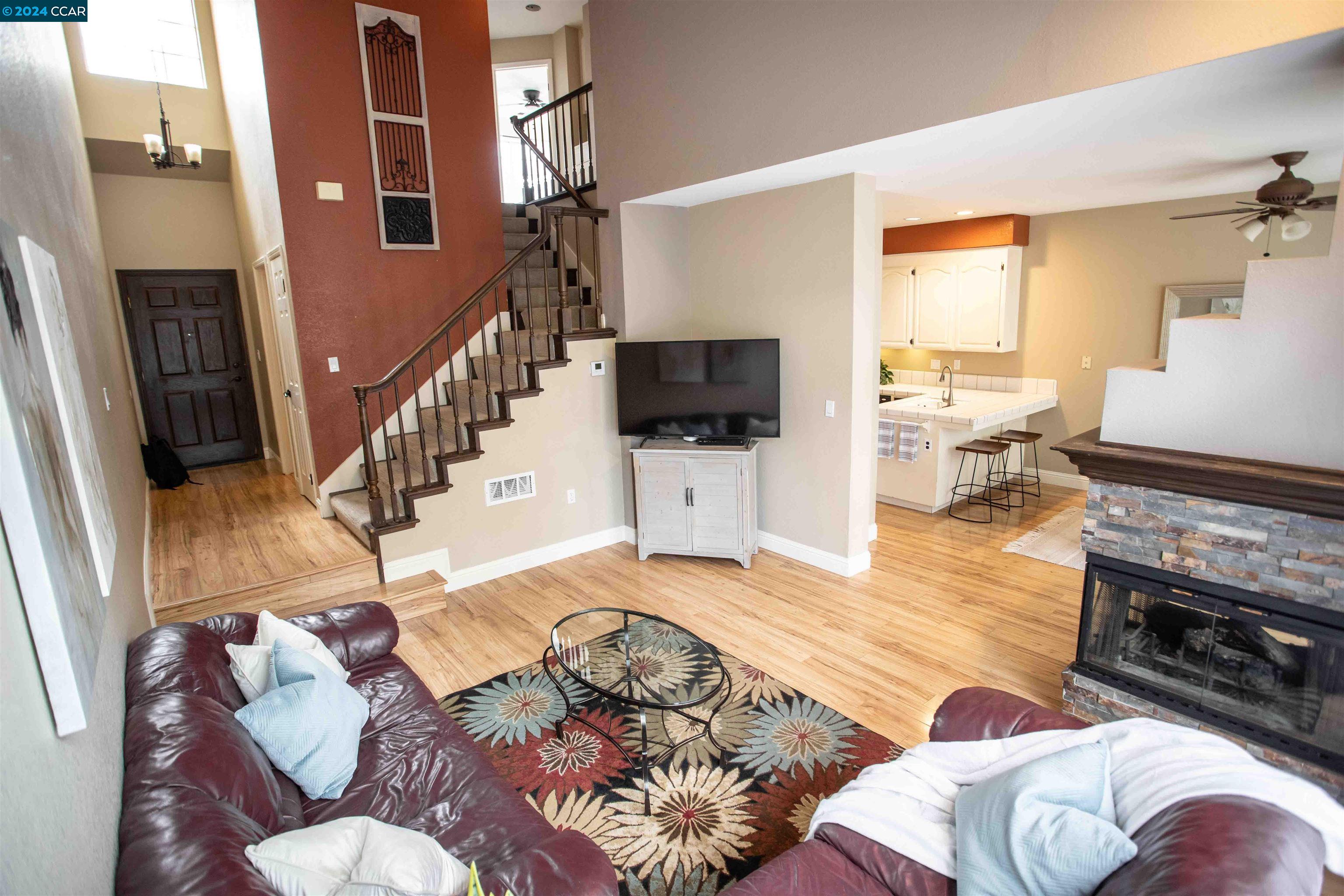 a living room with furniture fireplace and a flat screen tv