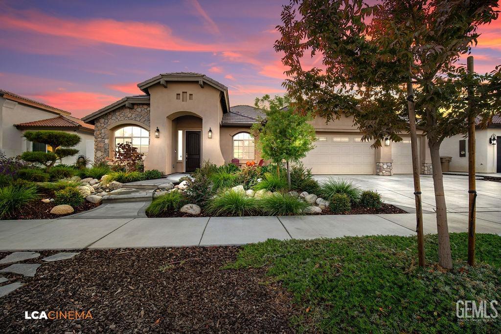 a front view of a house with garden