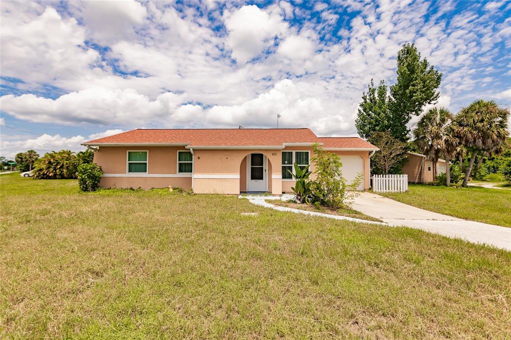 a front view of house with yard and green space