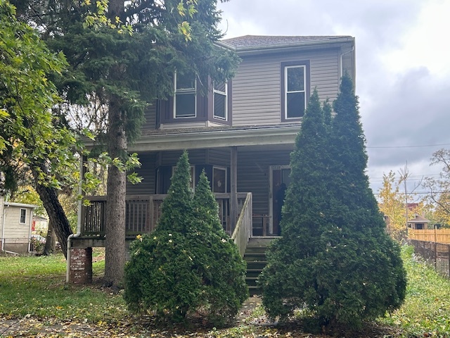 front view of a house with a tree