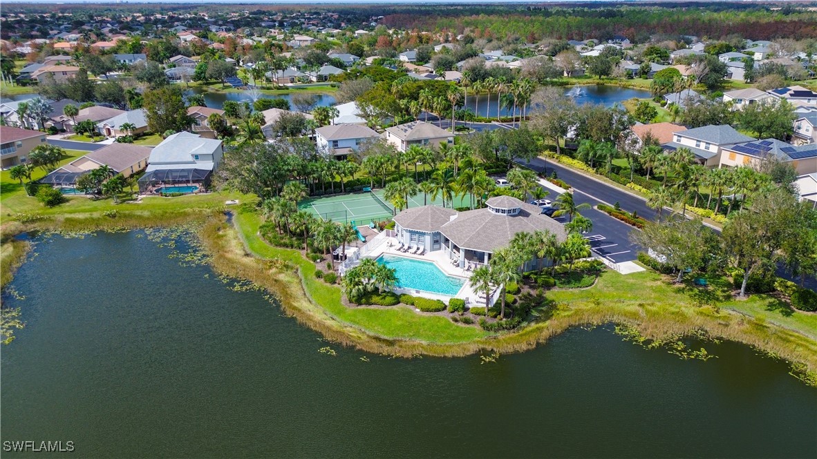 an aerial view of residential houses with outdoor space and swimming pool