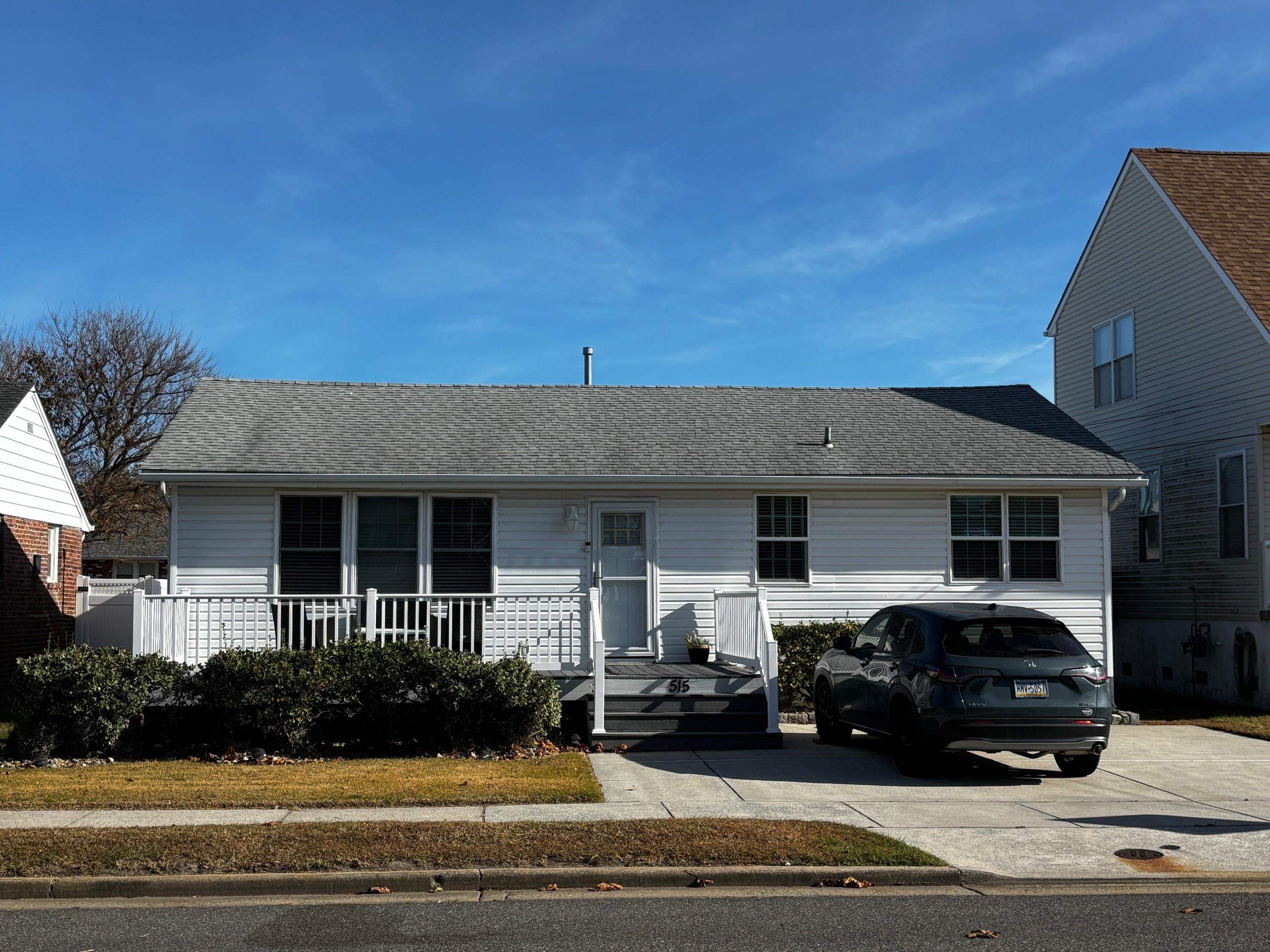 a view of a car parked front of a house