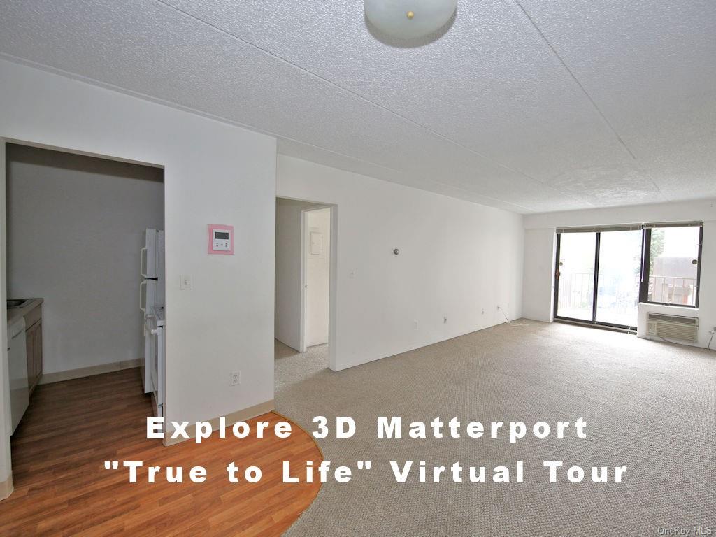 Empty room featuring carpet floors and a textured ceiling