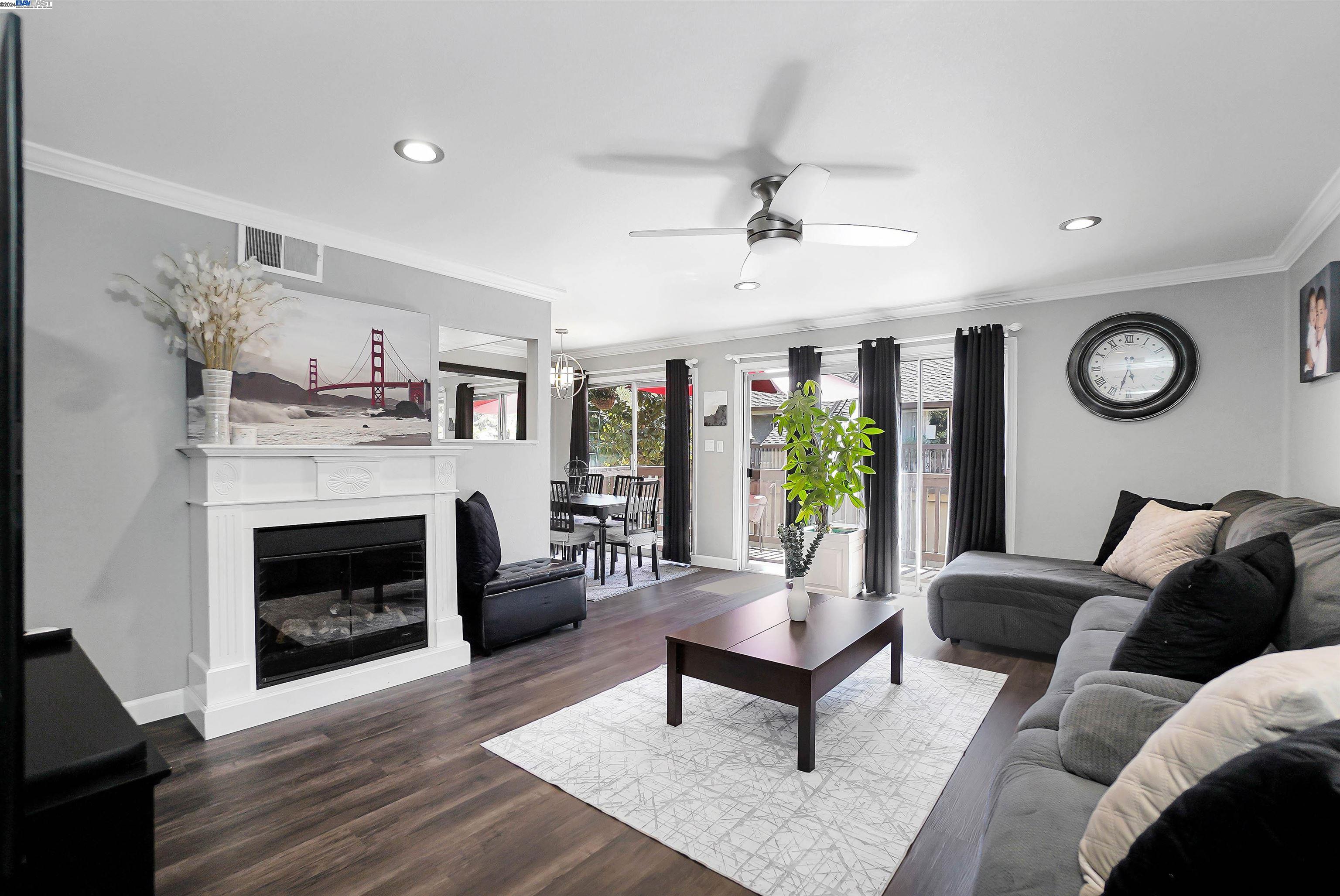 a living room with furniture a fireplace and a window