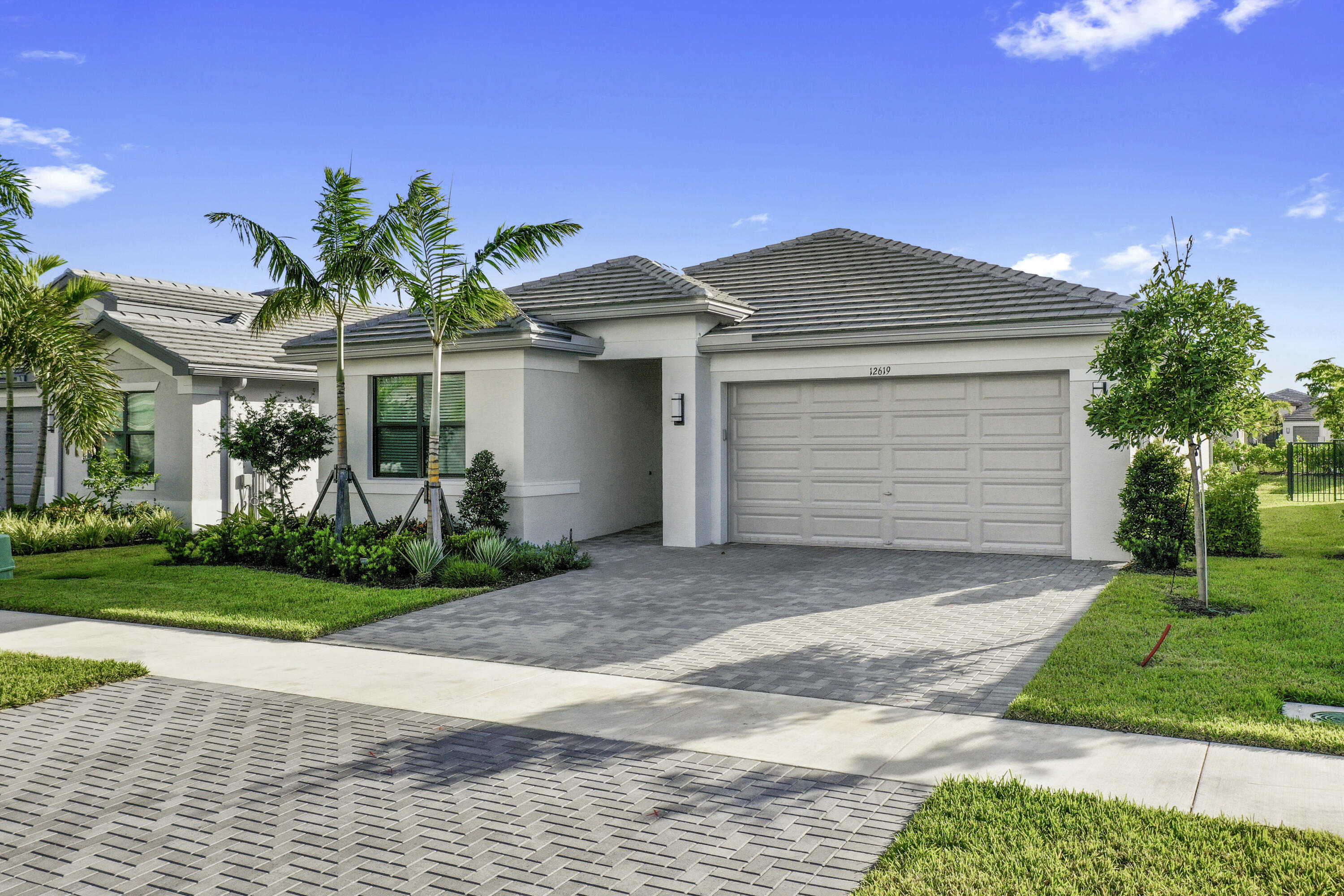 a front view of a house with a yard and garage