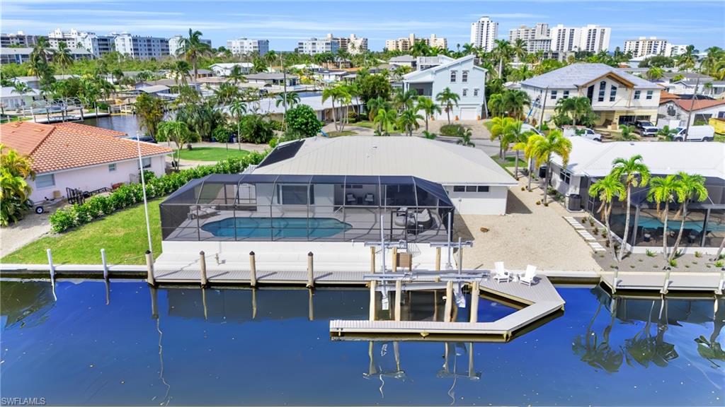 a aerial view of a house with swimming pool and ocean view