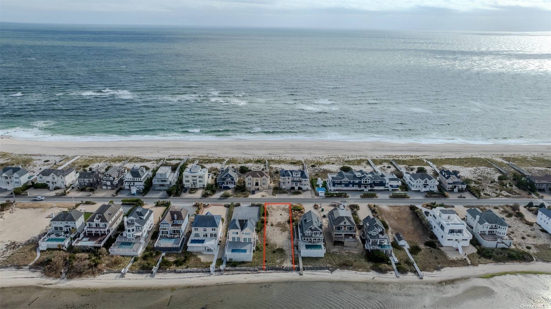 a view of a big yard with an ocean view