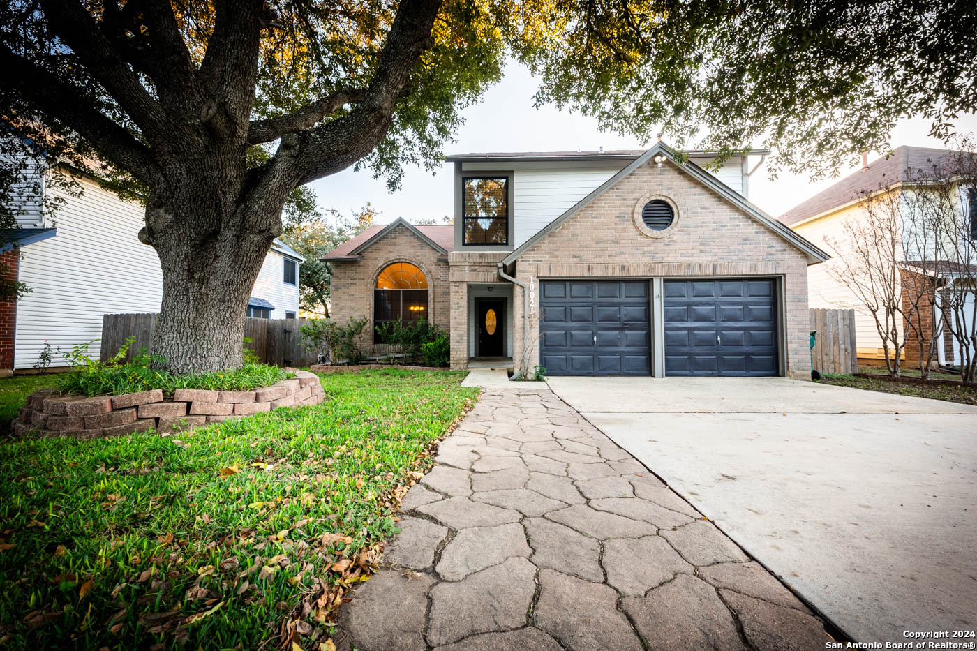 a front view of a house with a yard and garage