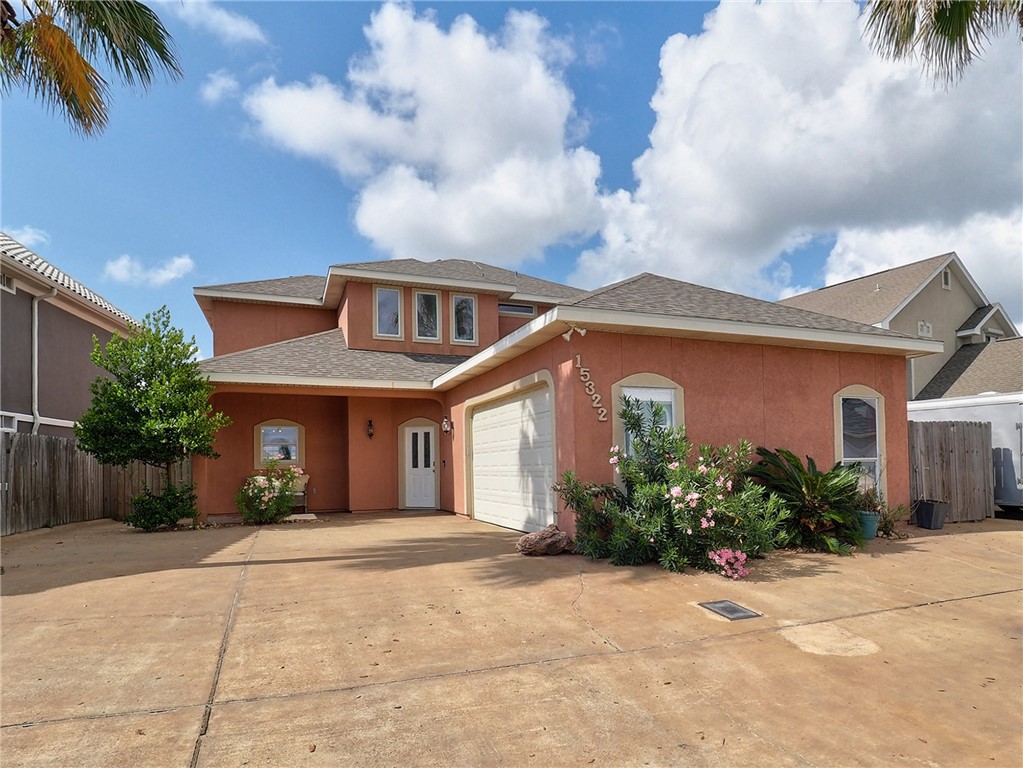 a front view of a house with a yard and a garage