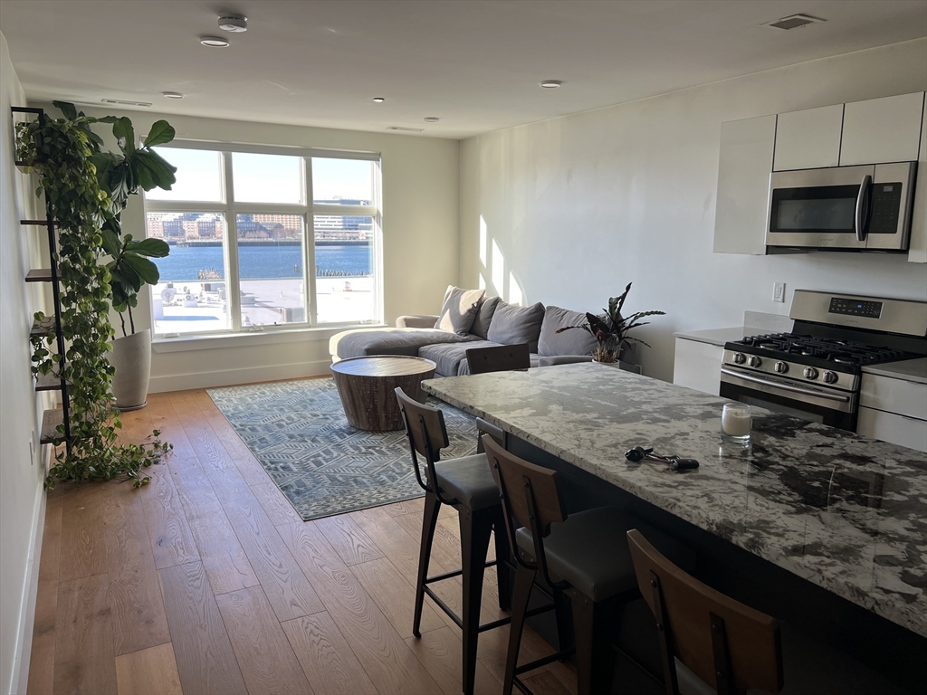 a kitchen with a table chairs sink and cabinets