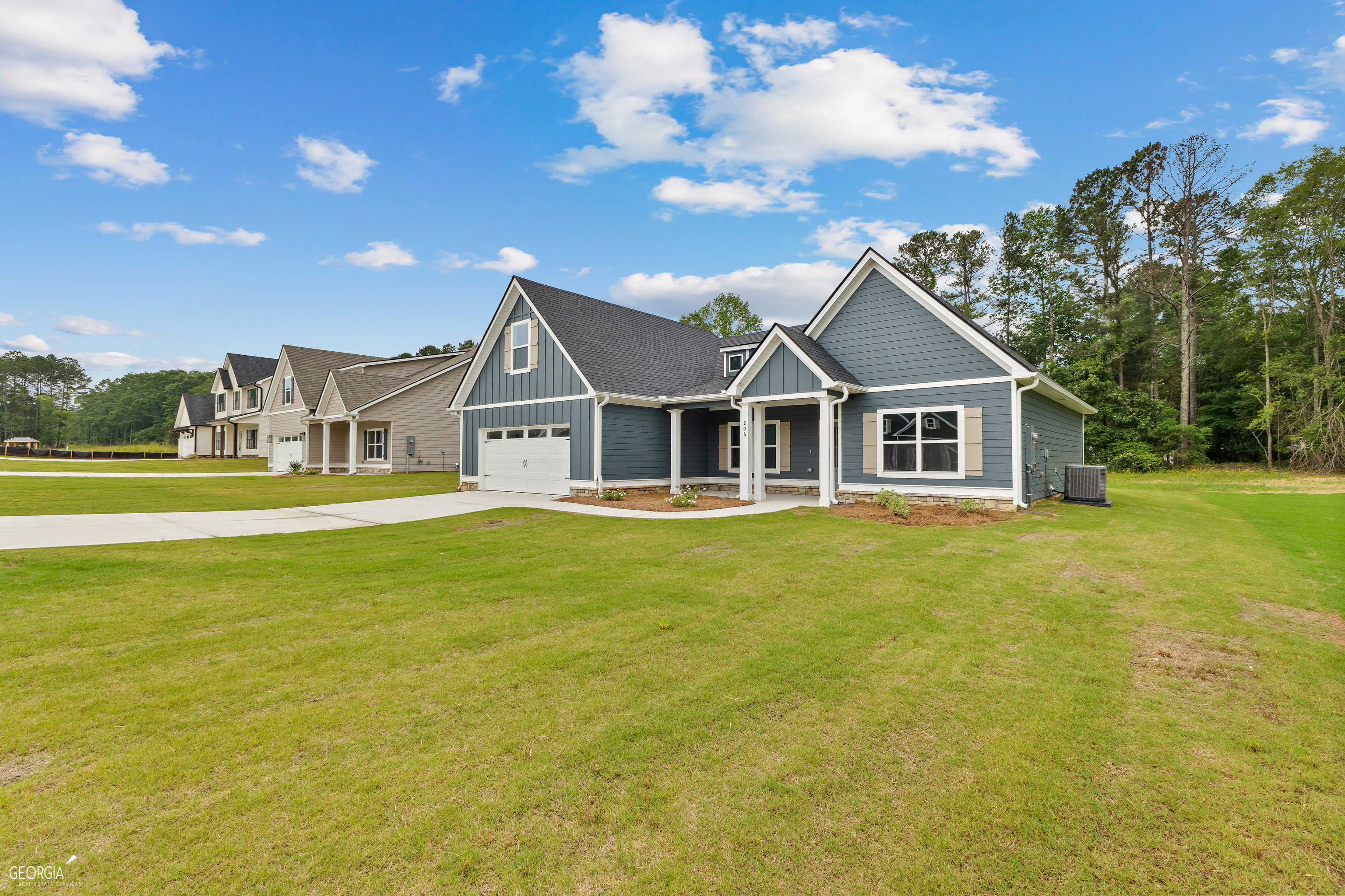 a front view of a house with a garden