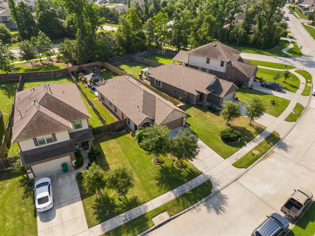 an aerial view of a house with a yard and potted plants