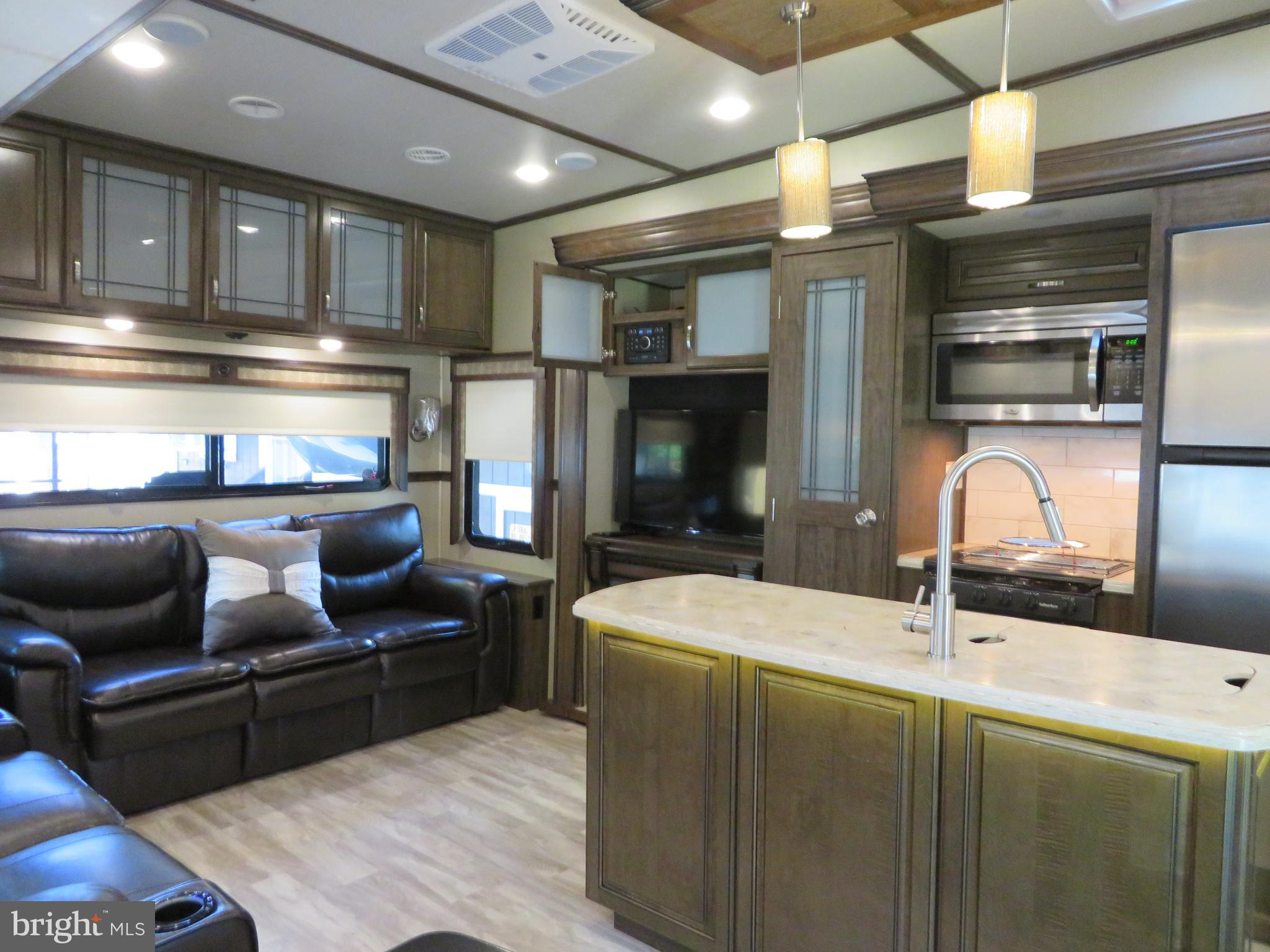 a kitchen with stainless steel appliances kitchen island granite countertop a sink and cabinets